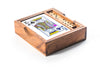 Wooden box containing playing cards and dominoes on a white background