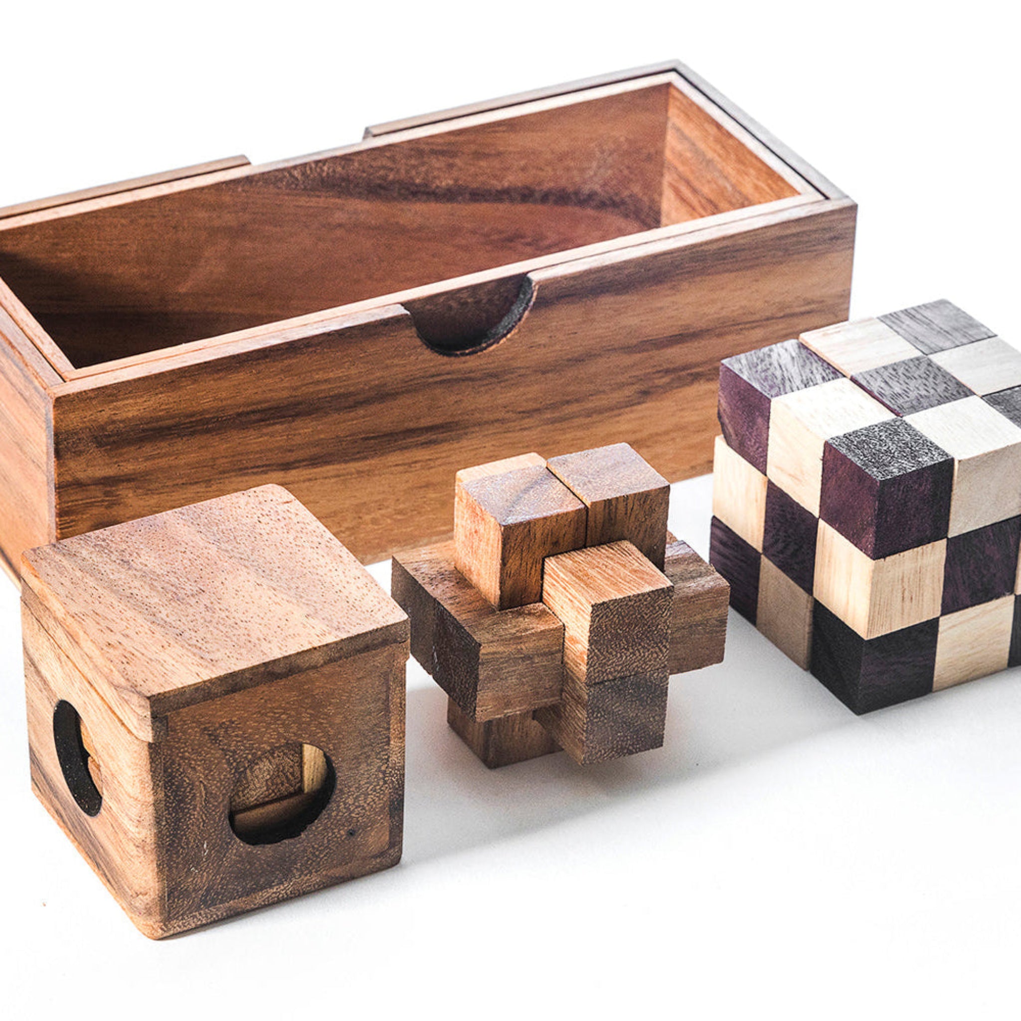 Wooden puzzle boxes of various sizes on a white background