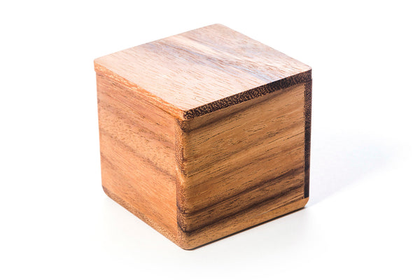 Wooden box with pyramid puzzle pieces showing how they fit inside with lid closed