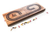 Wooden cribbage board with pegs on a white background