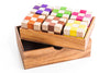 Colorful checkered blocks in a wooden box on a white background
