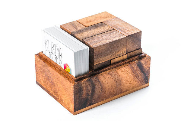Wooden business card holder with business cards on a white background