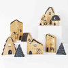A set of wooden blocks designed to look like various woodland creatures and houses, with intricate black and white illustrations on them, displayed against a neutral background.
