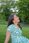 Close-up of Fair Anita wood and brass geometric stud earrings showing natural wood texture and brass finish