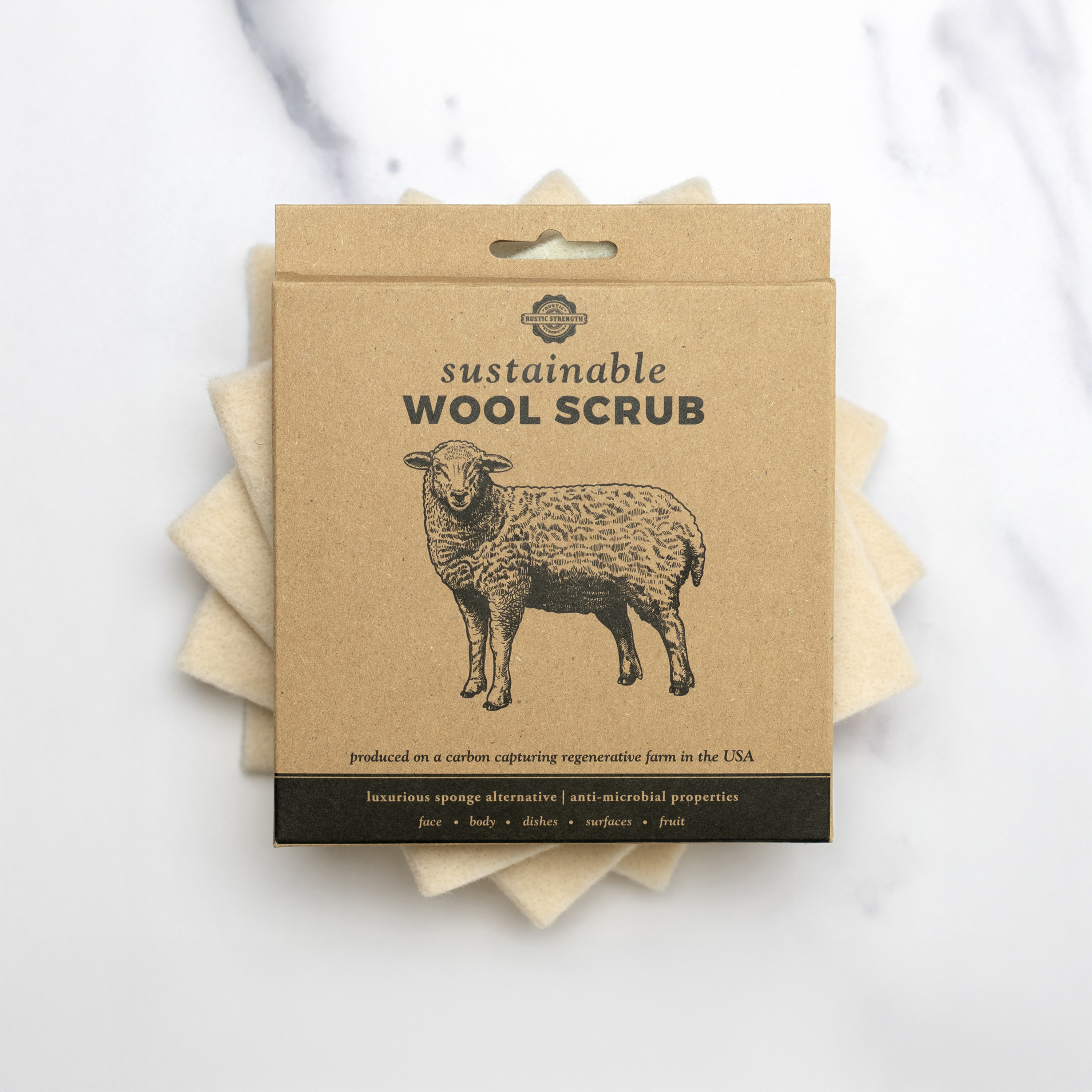 Rustic Strength sustainable wool scrub shown next to dishes – eco-friendly cleaning for home use