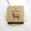 Rustic Strength sustainable wool scrub shown next to dishes – eco-friendly cleaning for home use