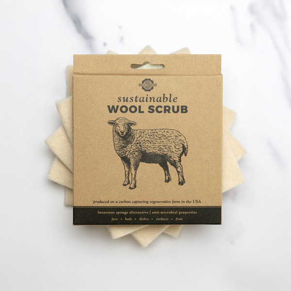 Rustic Strength sustainable wool scrub shown next to dishes – eco-friendly cleaning for home use