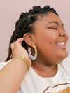 Fair Anita woven hoop earrings styled as a model wears them, showing full 2.75 inch drop