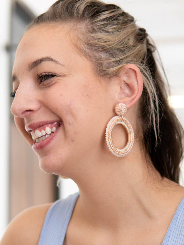 Woven pink statement hoop earrings by Fair Anita – front view on model