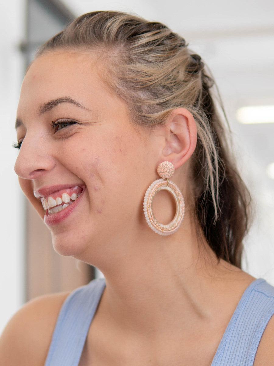 Woven pink statement hoop earrings by Fair Anita – close-up detail of beads and cord