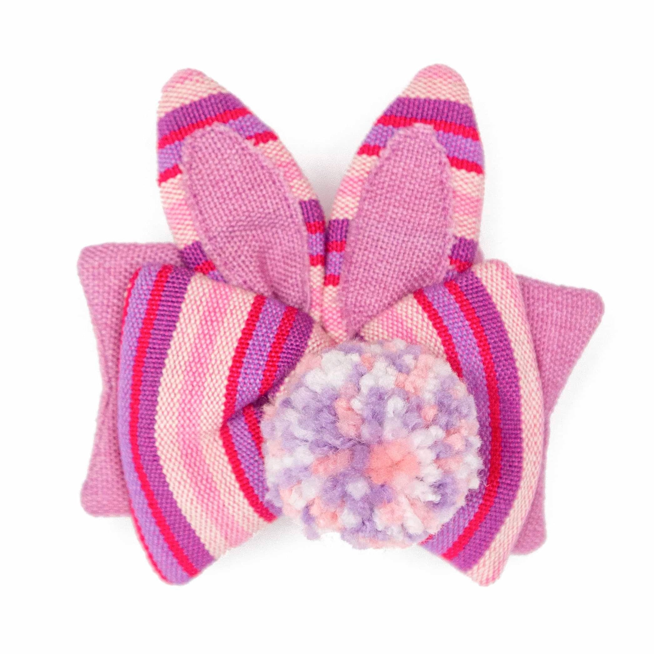 Little Bunny Fair Trade and Handmade Our new Little Bunny Scrunchies are a unique variation of our best-selling traditional and are sure to look cute in your little one's hair or yours! Featuring a dual bow with a fuzzy pom-pom and two cute rabbit ears, these scrunchies are a must-have for Spring! Choose between a beautiful pink or a vibrant peach color. As always, Handmade and Fair Trade!