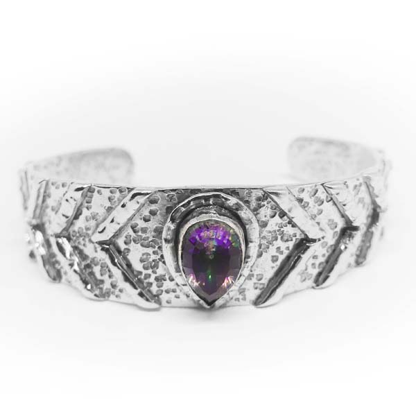 Discover the mystical beauty of our handcrafted Mystic Topaz Bangle. This unique and sustainable piece is made with love and care, using recycled metals and ethically sourced gemstones. Elevate your style and empower your spirit with this stunning accessory.