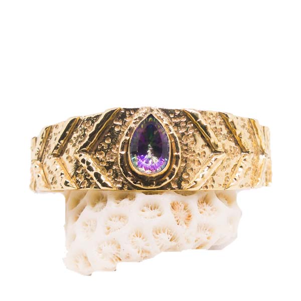 Discover the mystical beauty of our handcrafted Mystic Topaz Bangle. This unique and sustainable piece is made with love and care, using recycled metals and ethically sourced gemstones. Elevate your style and empower your spirit with this stunning accessory.