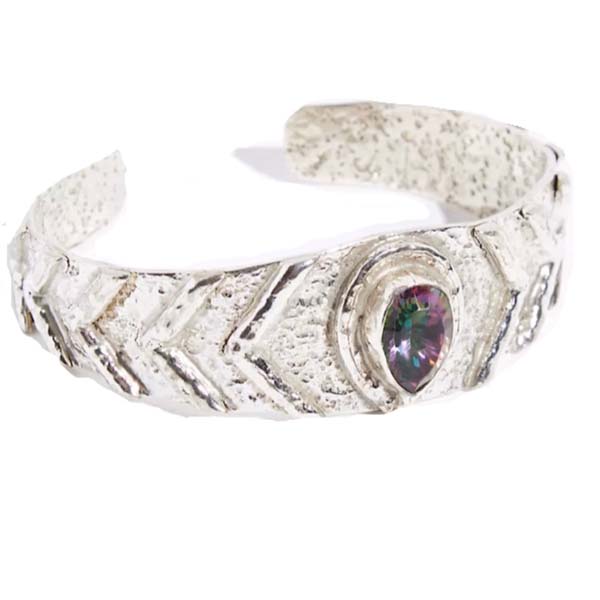 Discover the mystical beauty of our handcrafted Mystic Topaz Bangle. This unique and sustainable piece is made with love and care, using recycled metals and ethically sourced gemstones. Elevate your style and empower your spirit with this stunning accessory.