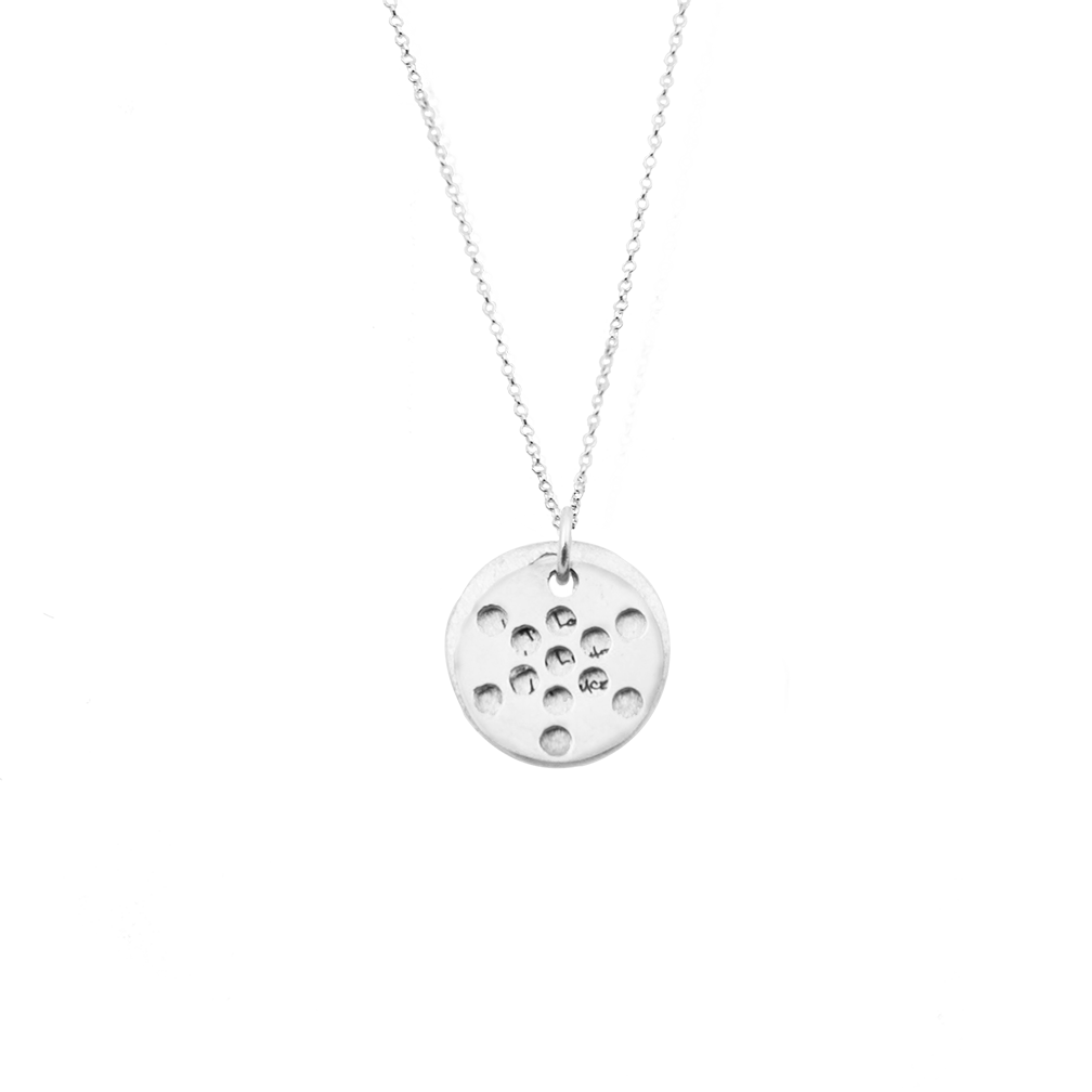 A close-up photo of the sacred geometry design on the pendant