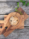 This handcrafted Albizia wood serving board is a beautiful and sustainable way to elevate your table setting. Ethically made and featuring unique wood grain variations, it's perfect for serving appetizers, cheese, and more. Shop now and support fair trade artisans!