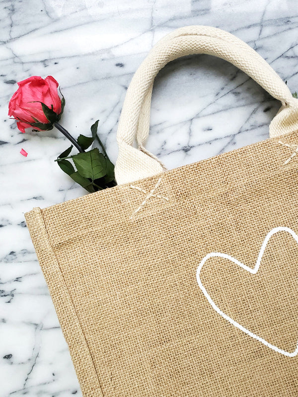 A stylish and sustainable gift bag made from natural jute. Perfect for any occasion, this reusable bag is both beautiful and eco-friendly.