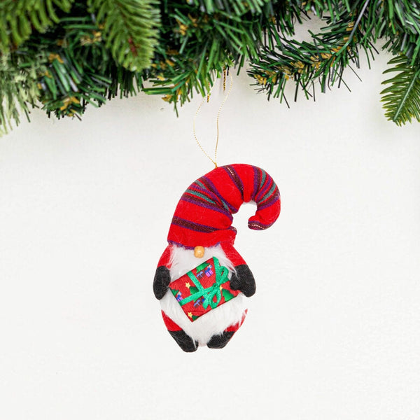 Santa Gnome Ornament - Embrace the festive cheer of Christmas with this captivating Santa Gnome Ornament, featuring a jolly gnome adorned in a traditional Guatemalan Corte hat and carrying a charming gift.