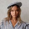 The Simone Beret Hat is a stylish and sustainable way to add a touch of personality to your wardrobe. It's made from soft gingham cotton and has a comfy linen lining, making it perfect for everyday wear. The Simone Beret Hat is also vegan and biodegradable, so you can feel good about wearing it knowing that it's not harming the environment.