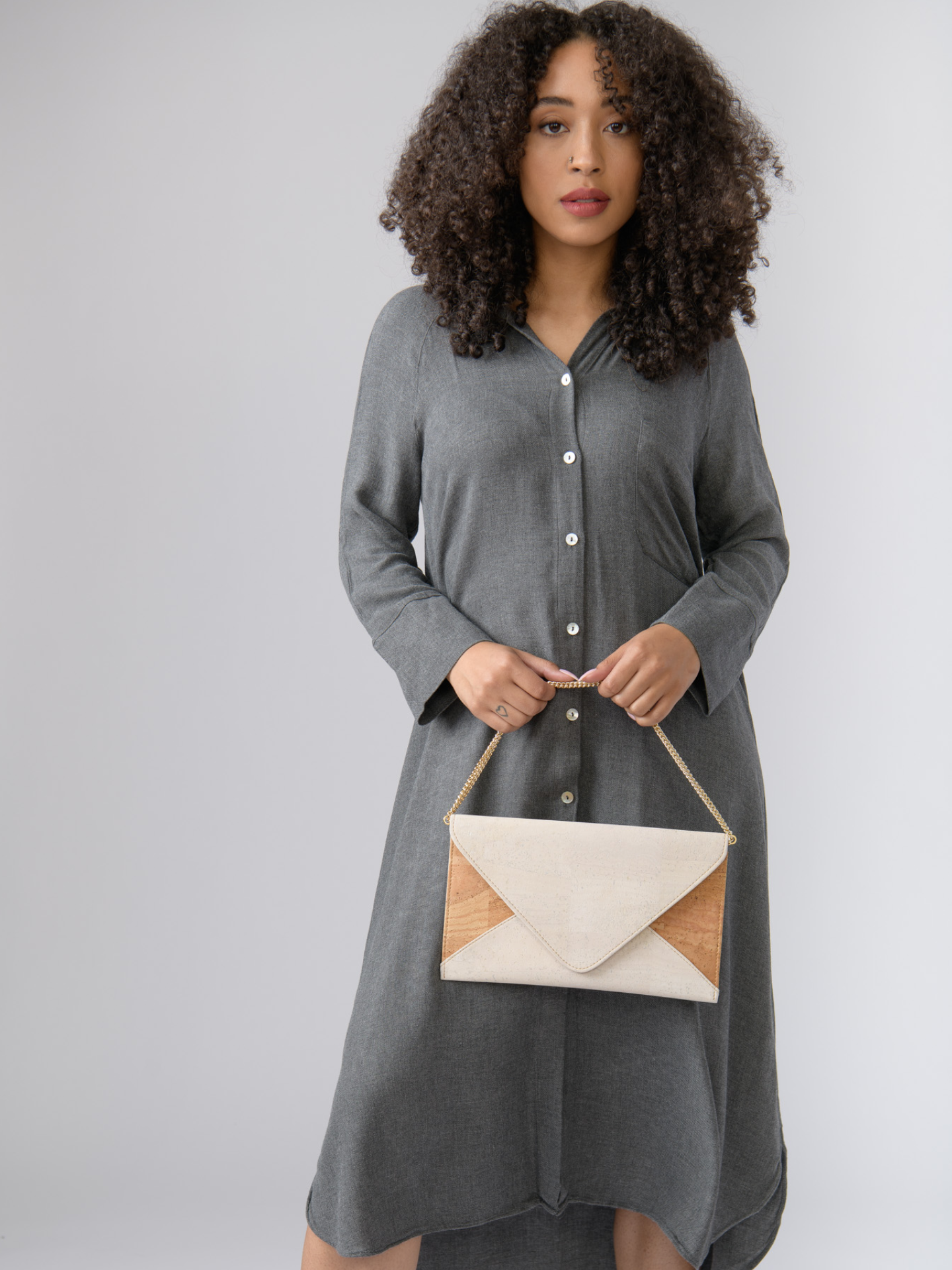 Versatile cork clutch for day or night. Stylish, eco-friendly, and vegan. Converts from clutch to crossbody. Spacious interior. Handmade in Portugal. Shop now!