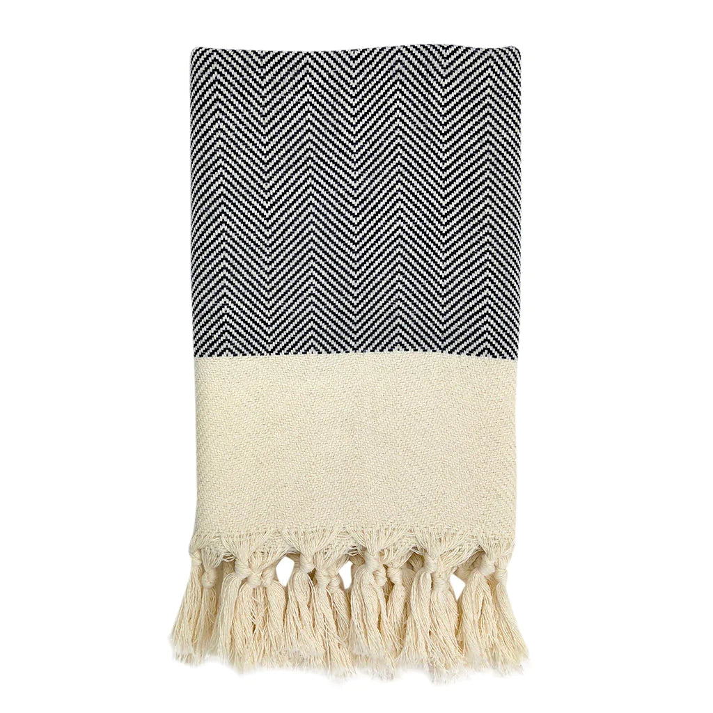 These Herringbone Turkish Hand Towels are highly absorbent and dry faster than traditional towels. Made from 100% Turkish cotton and artfully hand-knotted in Turkey, they become softer and fluffier over time. They are machine washable and made with sustainable, natural fibers and non-toxic dyes. The tassels are hand-knotted by women in their homes, adding a personal touch. Perfect for refreshing any kitchen or bathroom.