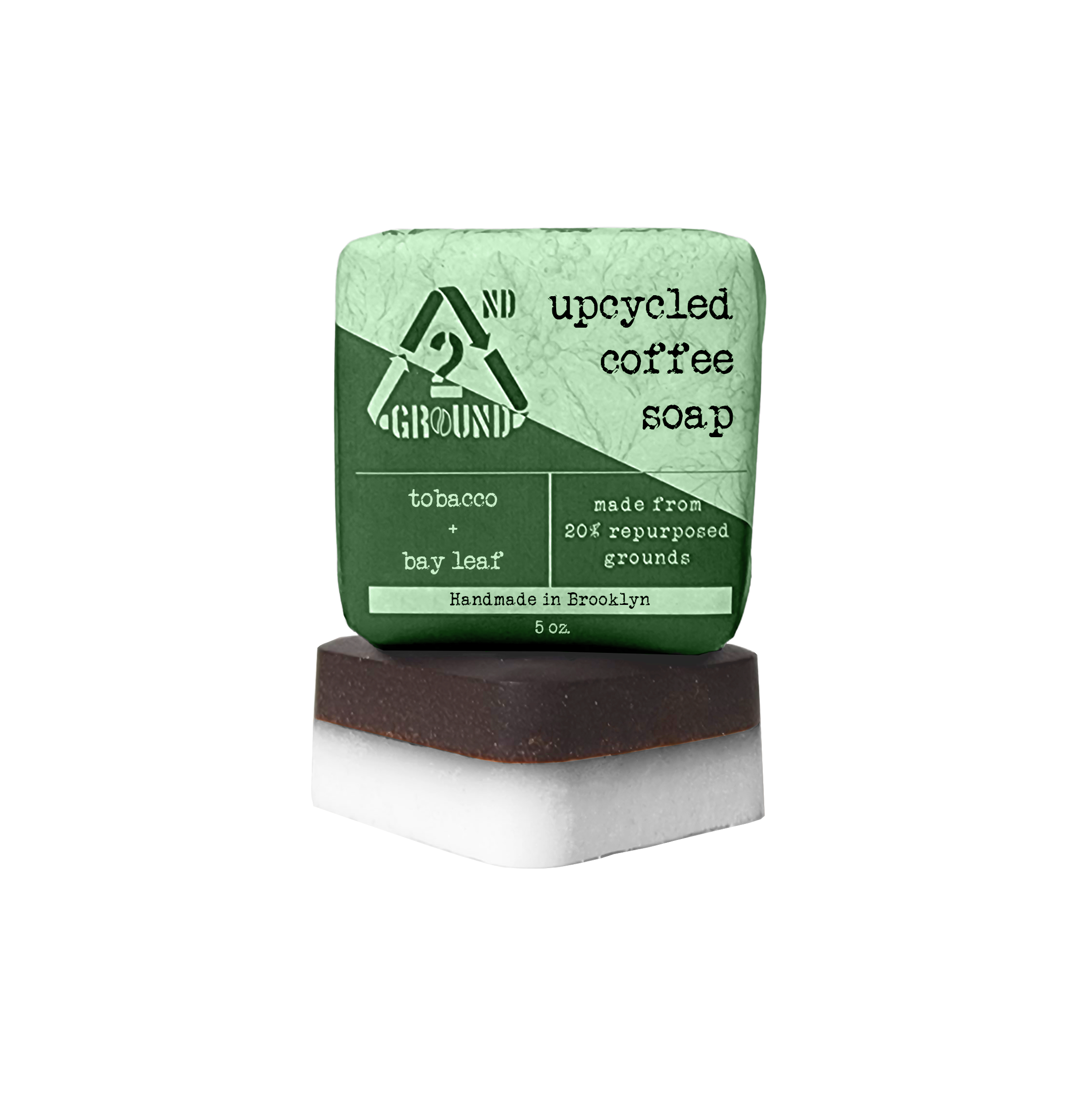 A close-up photo of the Coffee Soap bar, showing its coffee grounds and creamy texture. Description: Our Coffee Soap is made with all-natural ingredients, including coffee grounds, coconut oil, and shea butter. It is perfect for exfoliating and moisturizing your skin. Tobacco and bay leaf 