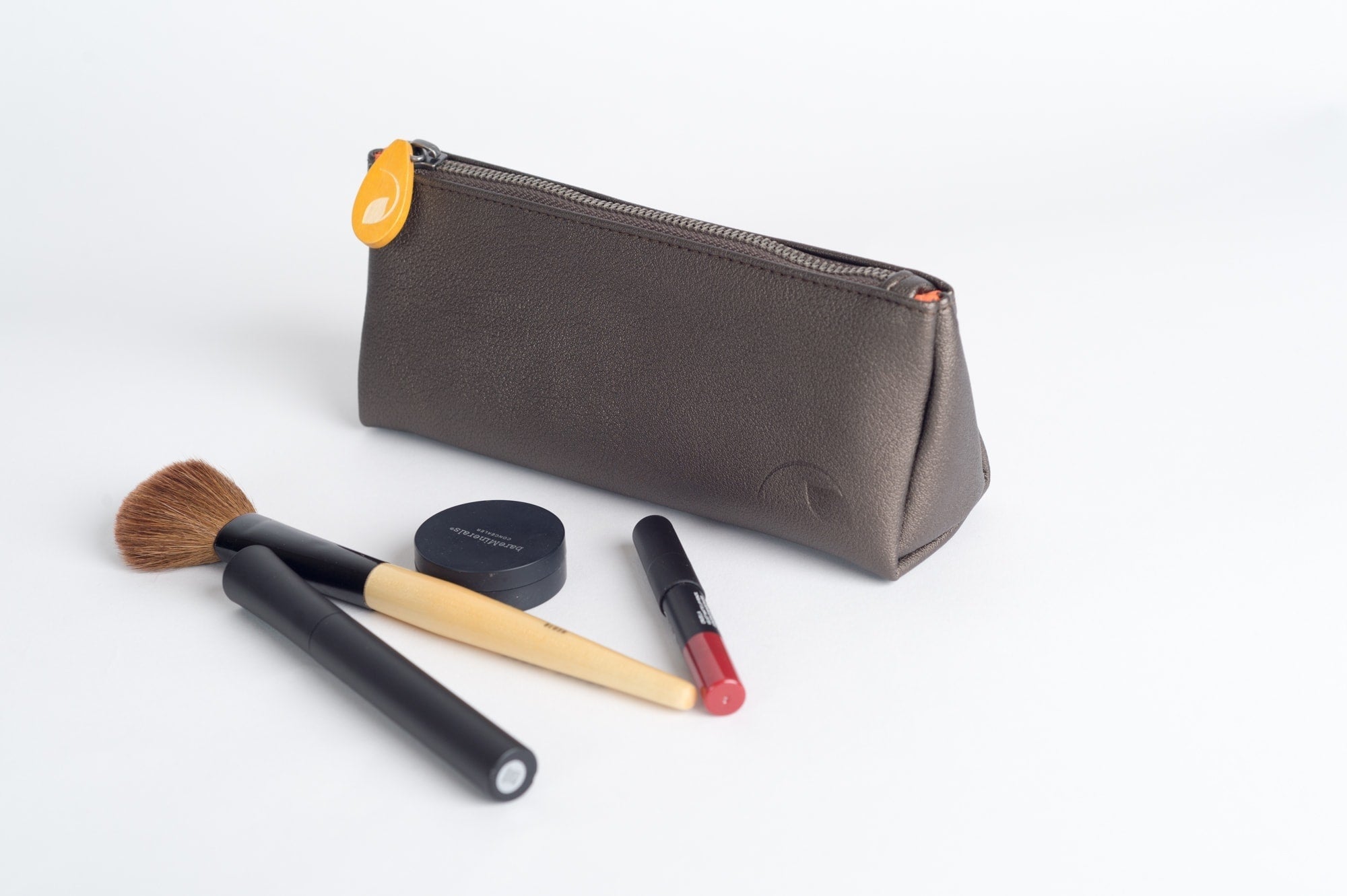 Elevate your essentials! Chic Union Pouch - vegan leather, orange lining, stands up, holds makeup, pens, brushes. Perfect gift set option. Shop sustainable accessories now!