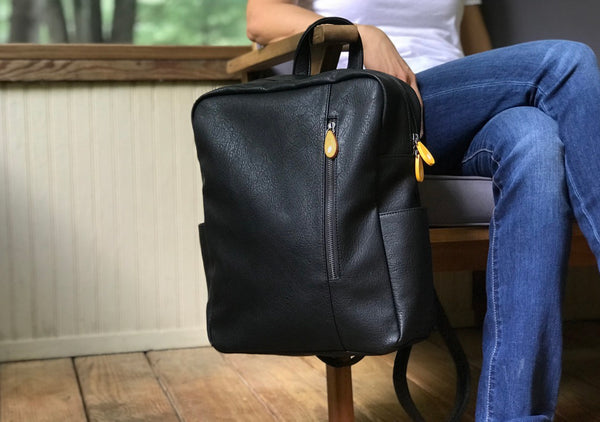 Chic vegan leather backpack! Lenox transitions from office to weekend (spacious, pockets, fits 13" laptop). Water bottle & umbrella pockets. Adjustable straps. Sustainable & organized. Shop now! 