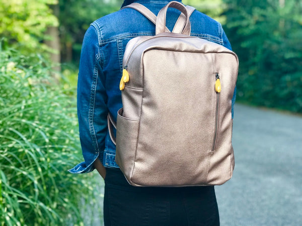 Chic vegan backpack! Lenox goes from office to weekend (spacious, pockets, fits 13" laptop). Water bottle & umbrella pockets. Adjustable straps. Sustainable & stylish. Shop now! Watch video!