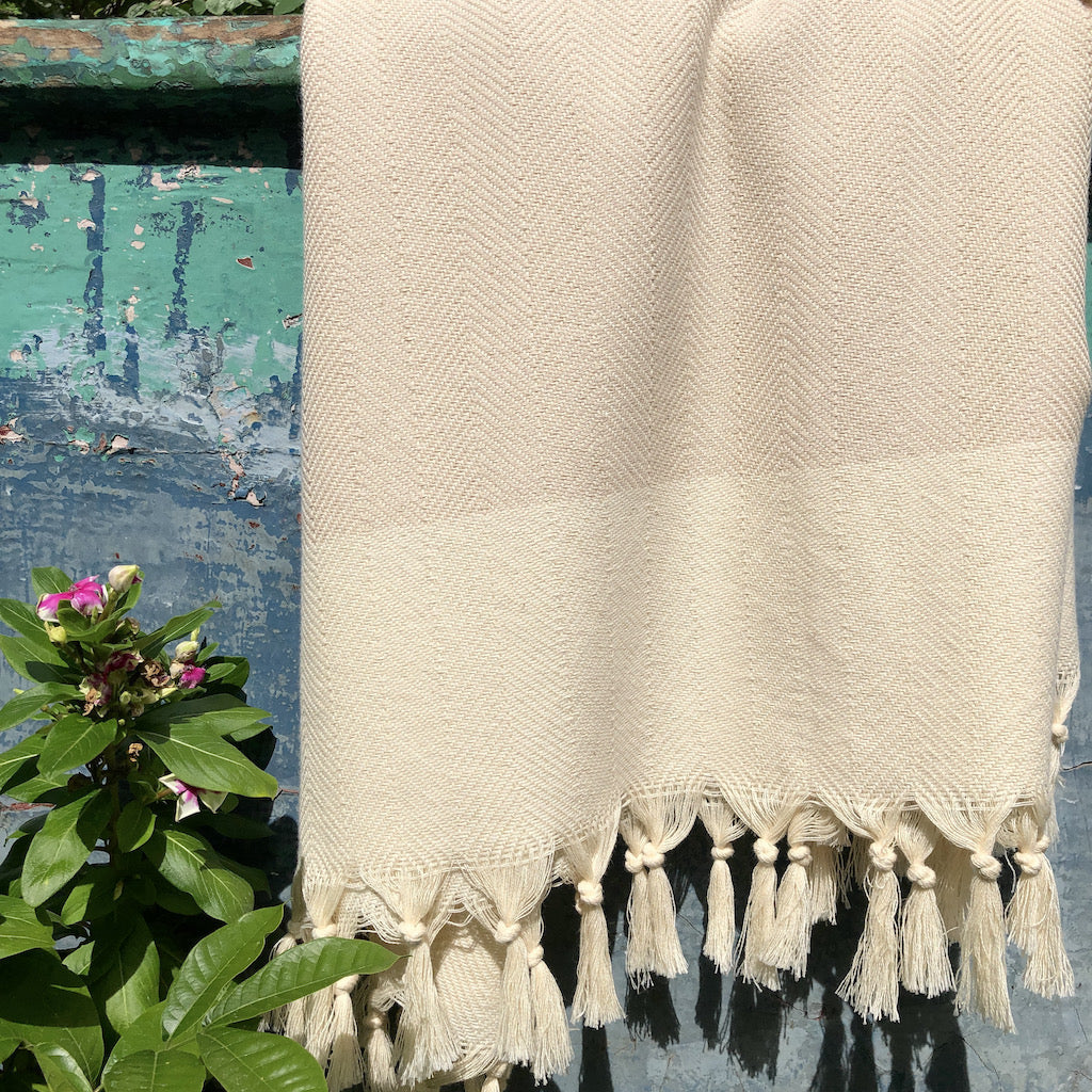 The Herringbone Turkish Towel boasts a traditional aesthetic bolstered by hand-knotted fringes. These towels boast more versatility than their classical counterparts, due to their increased size, and make perfect additions to bathrooms, beach spreads, and travel bags alike. Thanks to their low weight and fast-drying properties, users will no longer be satisfied with anything else.