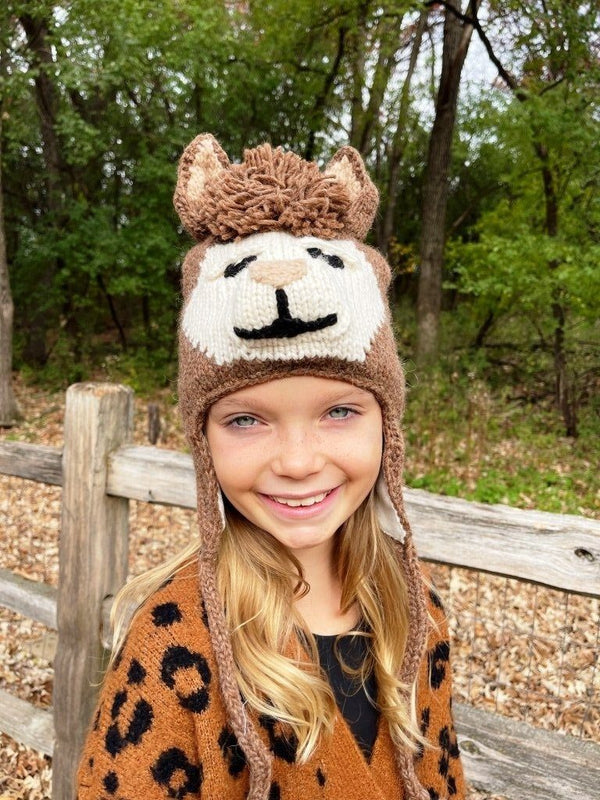A photo of the alpaca animal hat being worn by a child