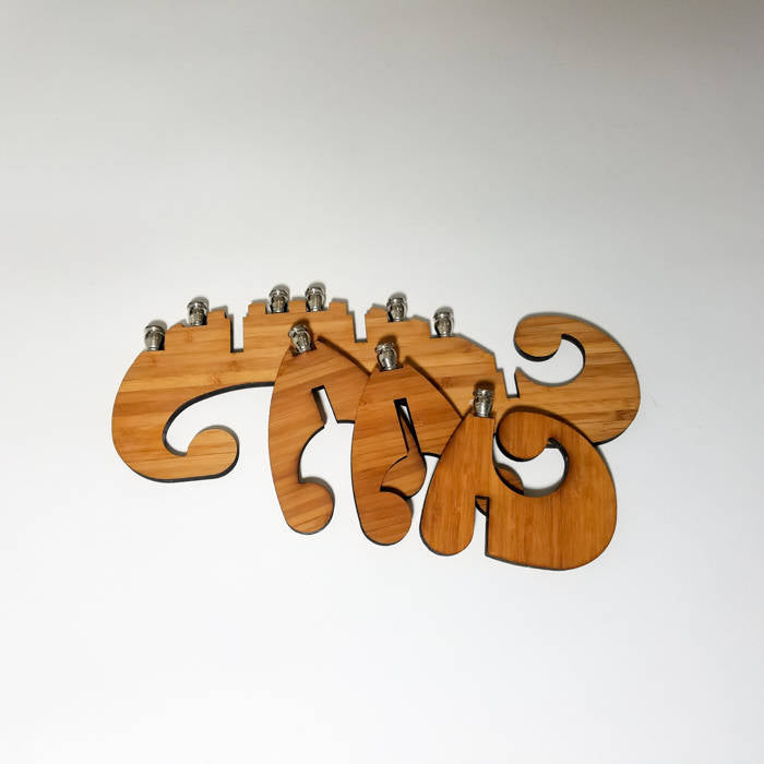 Add a touch of whimsy to your Hanukkah celebrations with our Swirl Menorah. Made from sustainable bamboo and featuring a unique design, this menorah is perfect for home use or travel. Order yours today!