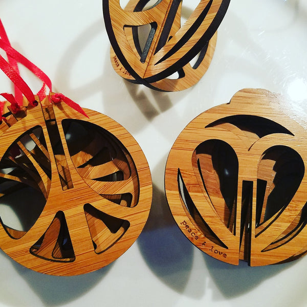 Spread the message of peace and love with our eco-friendly Bamboo Peace & Love Christmas Ornament. This laser-cut design is perfect for adding a touch of meaning and sustainability to your holiday celebrations. Order yours today!