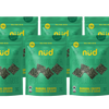Multiple packages of nud Spirulina Banana Crisps on a white background