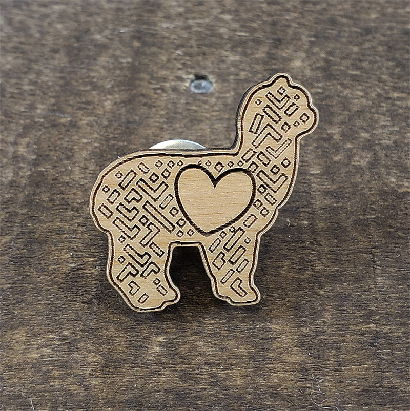 A close-up photo of the alpaca design on the pin