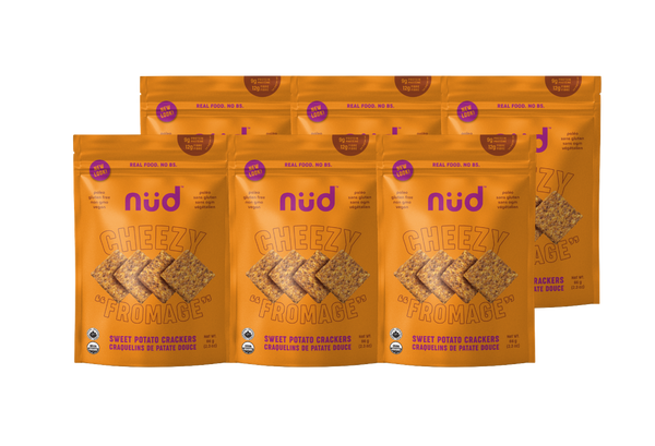 Multiple packages of nud Cheezy Parmage crackers on a white background