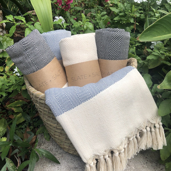 The Herringbone Turkish Towel boasts a traditional aesthetic bolstered by hand-knotted fringes. These towels boast more versatility than their classical counterparts, due to their increased size, and make perfect additions to bathrooms, beach spreads, and travel bags alike. Thanks to their low weight and fast-drying properties, users will no longer be satisfied with anything else.