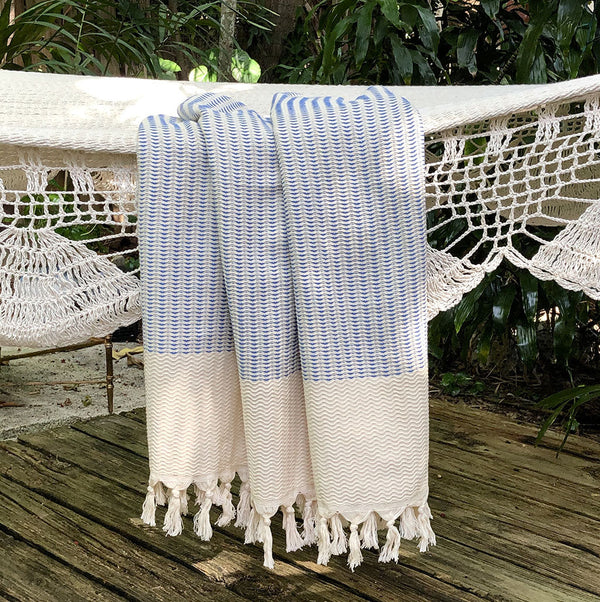 Experience a plush upgrade to your bathing and decor routines with the Plush Wavy Turkish Towels. Their size surpasses traditional towels, and they provide a versatile range of uses, from bath towels to beach blankets to sarongs. With the added convenience of being lightweight and quick-drying, our Turkish towels are ideal for travel or home use. Those accustomed to terry towels may never go back once they've tried this luxurious alternative! We also offer a larger size.