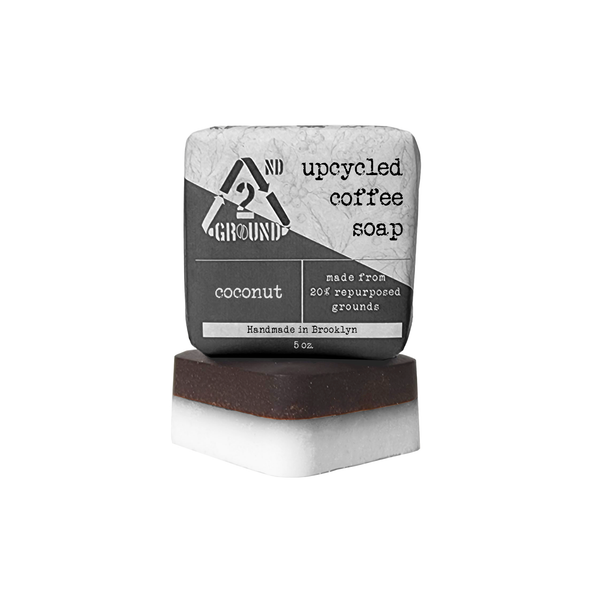 A close-up photo of the Coffee Soap bar, showing its coffee grounds and creamy texture. Description: Our Coffee Soap is made with all-natural ingredients, including coffee grounds, coconut oil, and shea butter. It is perfect for exfoliating and moisturizing your skin. coconut