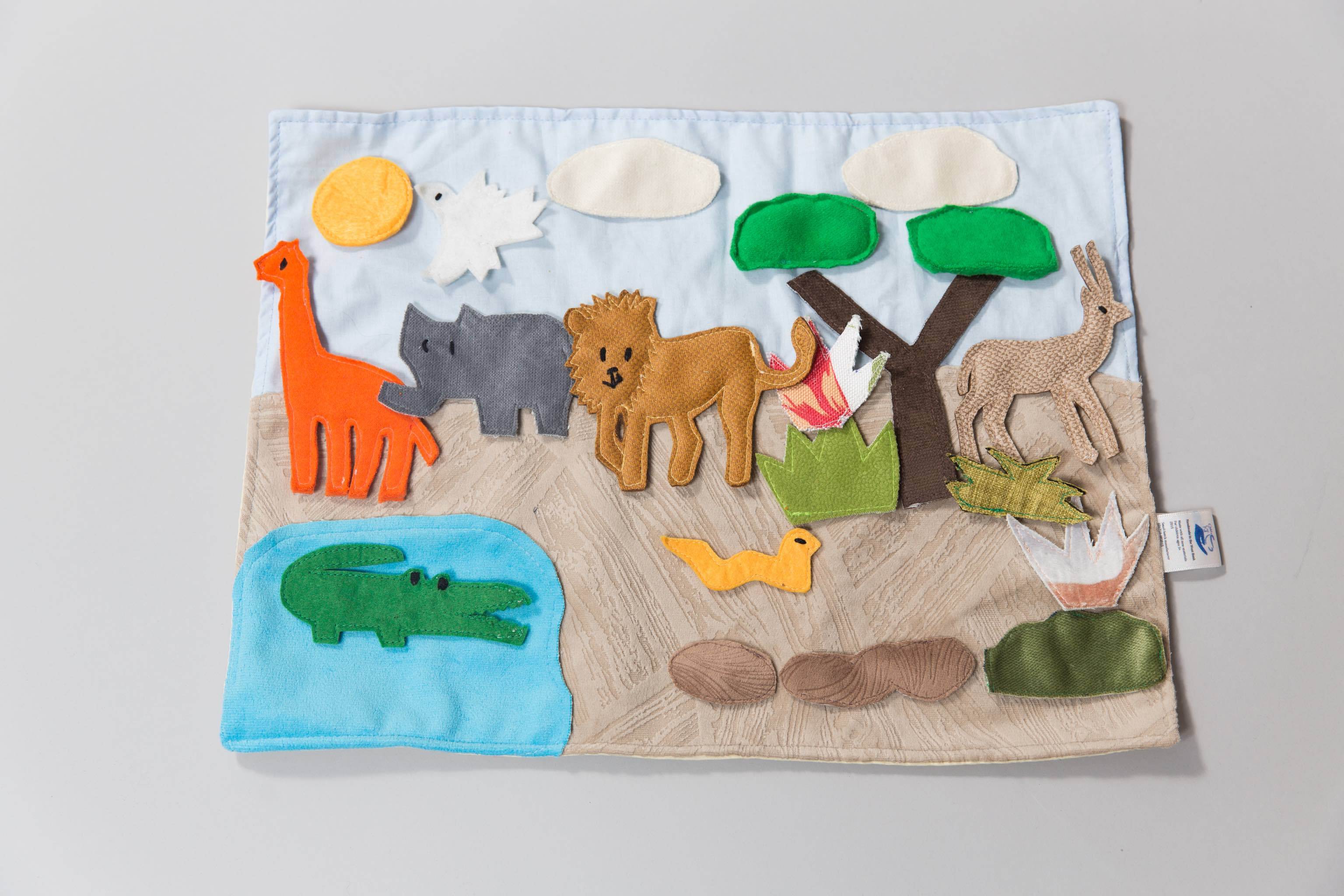 A photo of the Safari Habitat Storyboard playmat and pieces